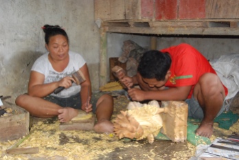 Wood carvers working in their shop